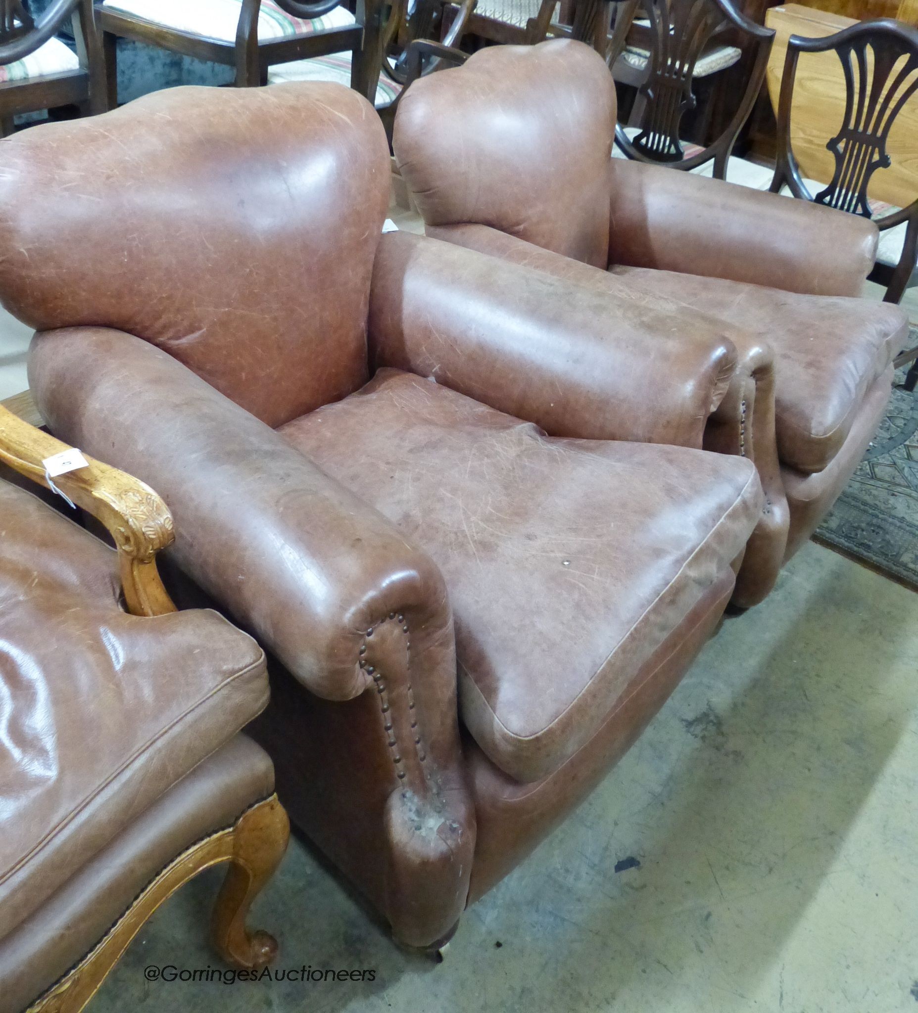 A pair of 1940's French tan leather club armchairs, width 90cm, depth 88cm, height 82cm